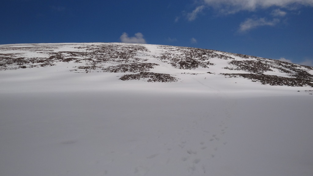 Footprint in the snow leading to the top of the mountain