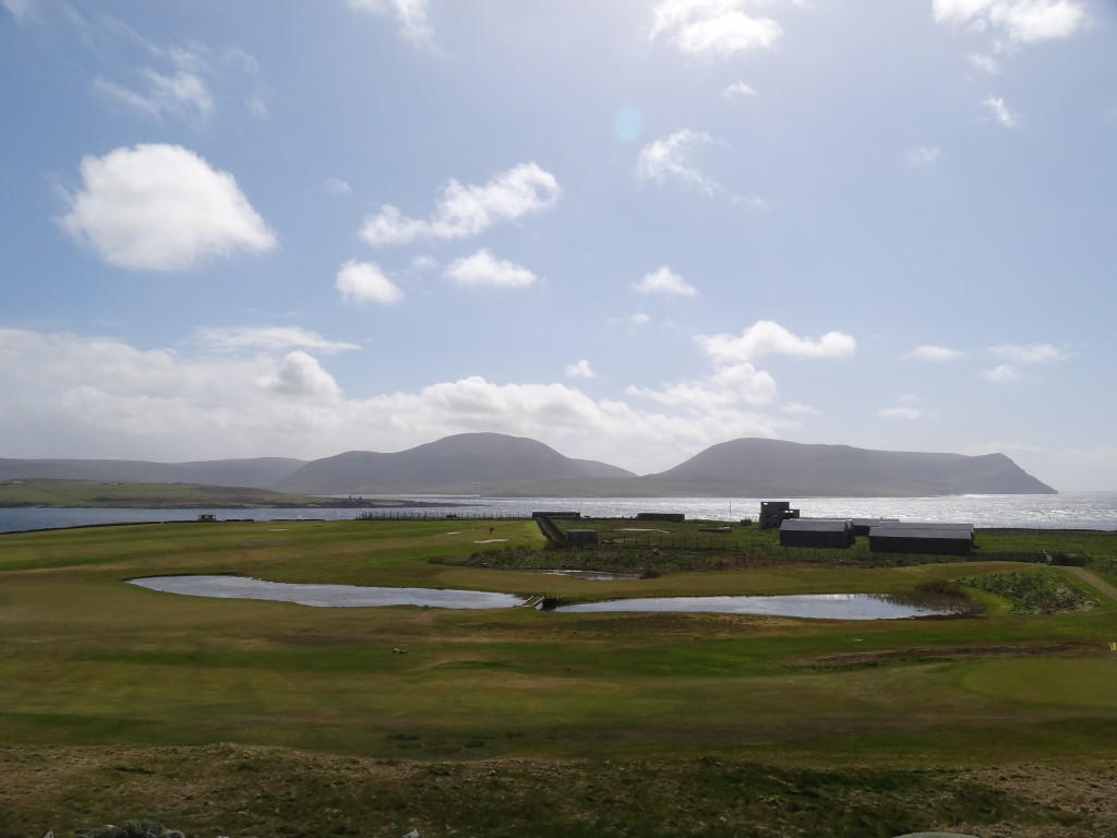 lake with view of the sea and mountains in the distance