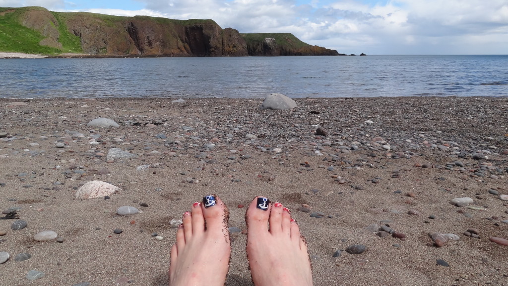 toes with a beach and cliffs in the background