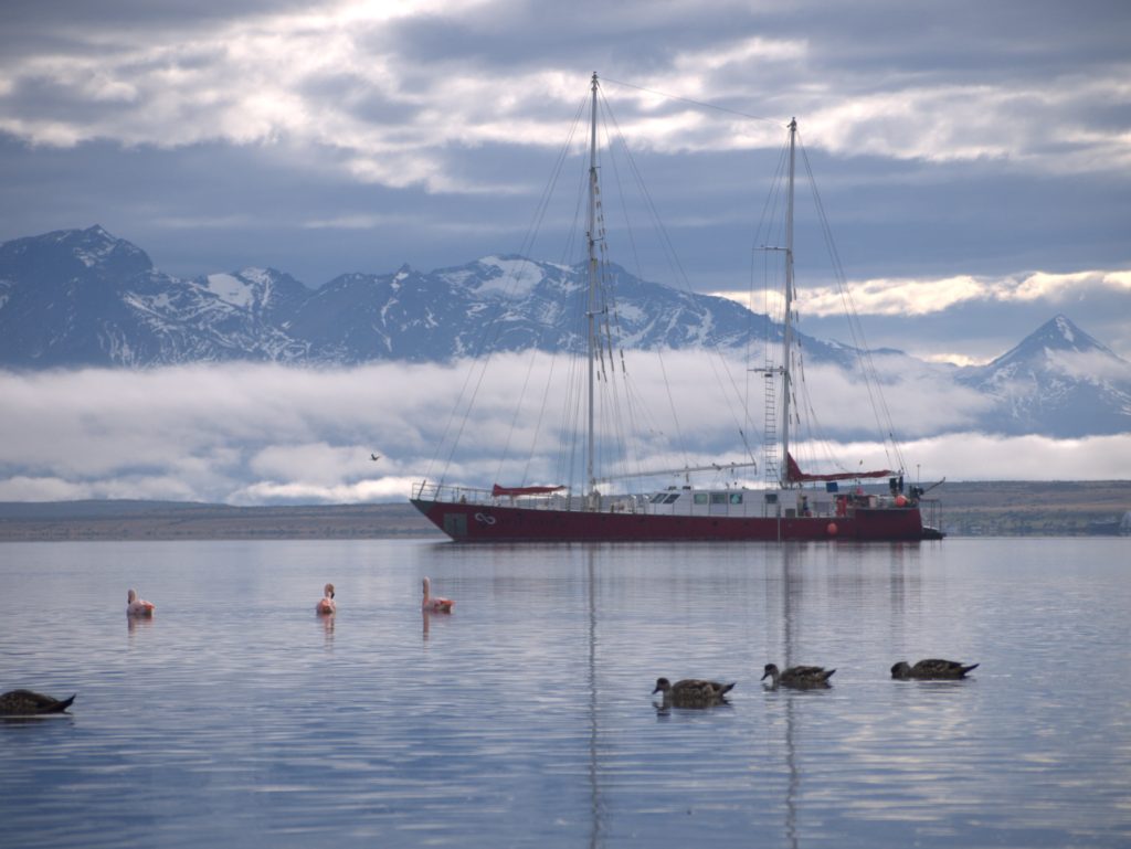 Infinity Expedition - Sailing vessel Infinity with mountains in the background