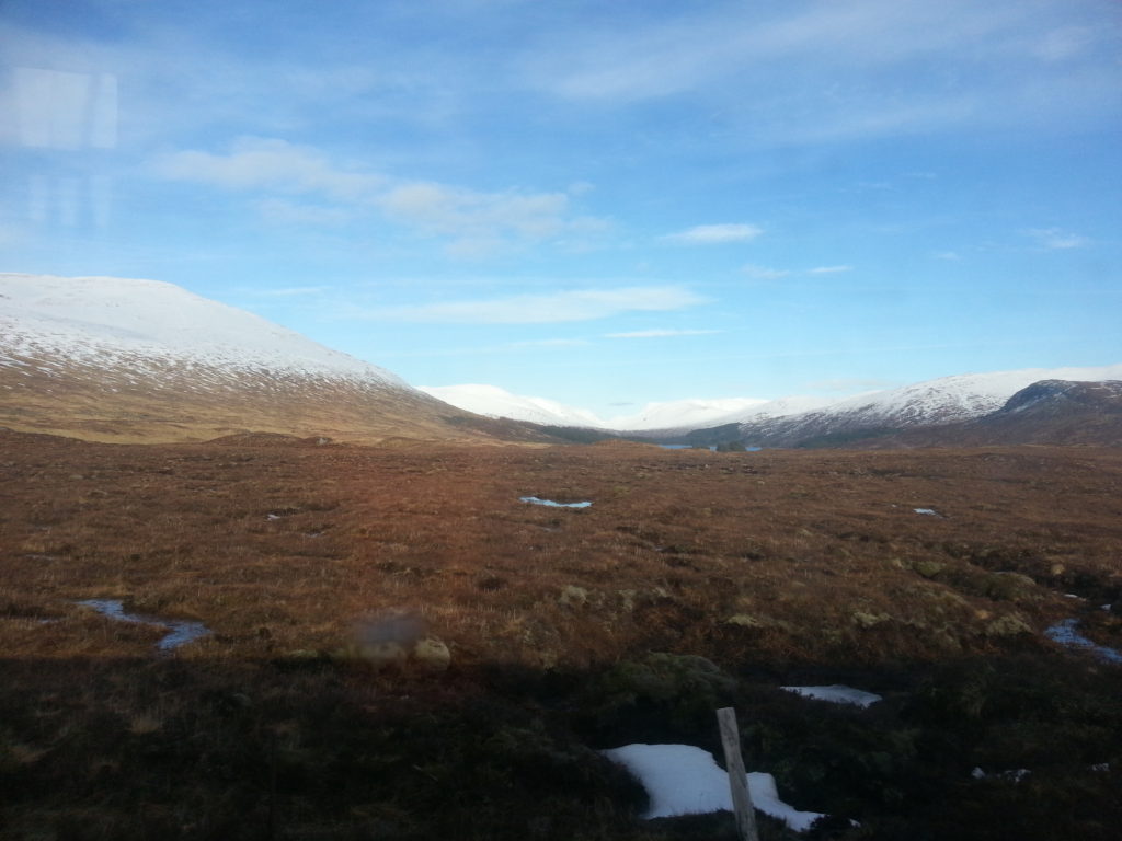 Snow covered rolling hills surrounding a plain