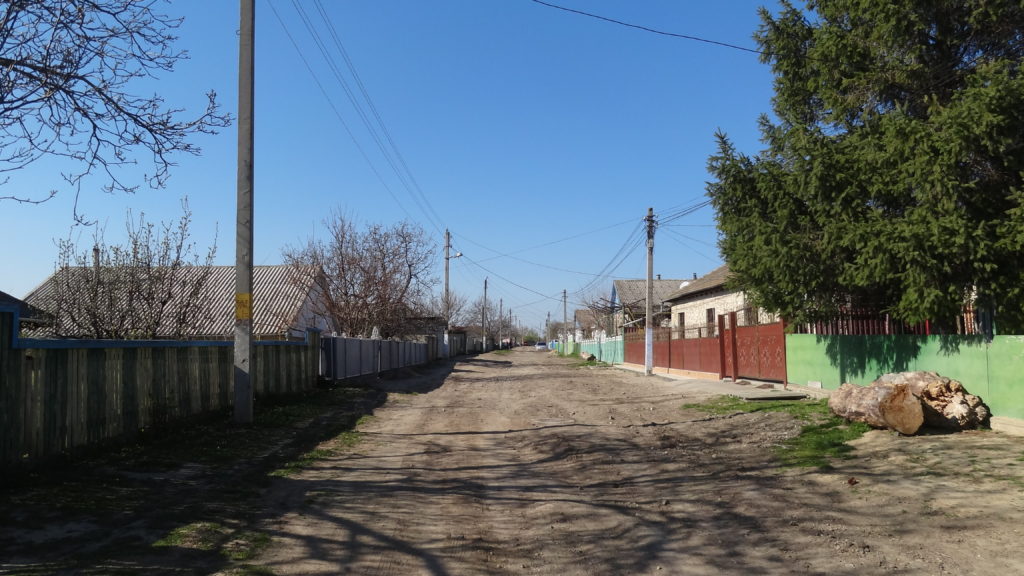 Unpaved street, dusty when dry, very muddy and slippery when wet