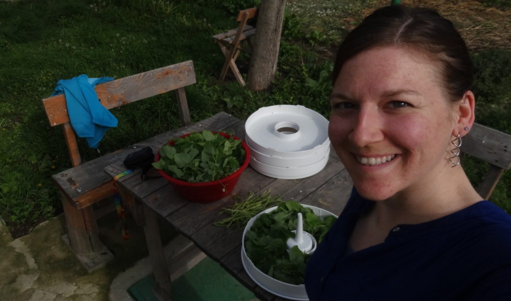 Happily cutting herbs to dry them