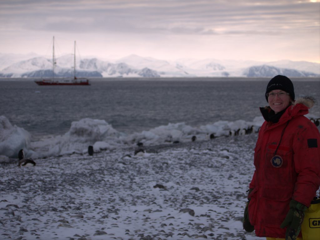 Infinity Expedition - Me on Ridley Beach, Antarctica with penguins and Infinity in the background