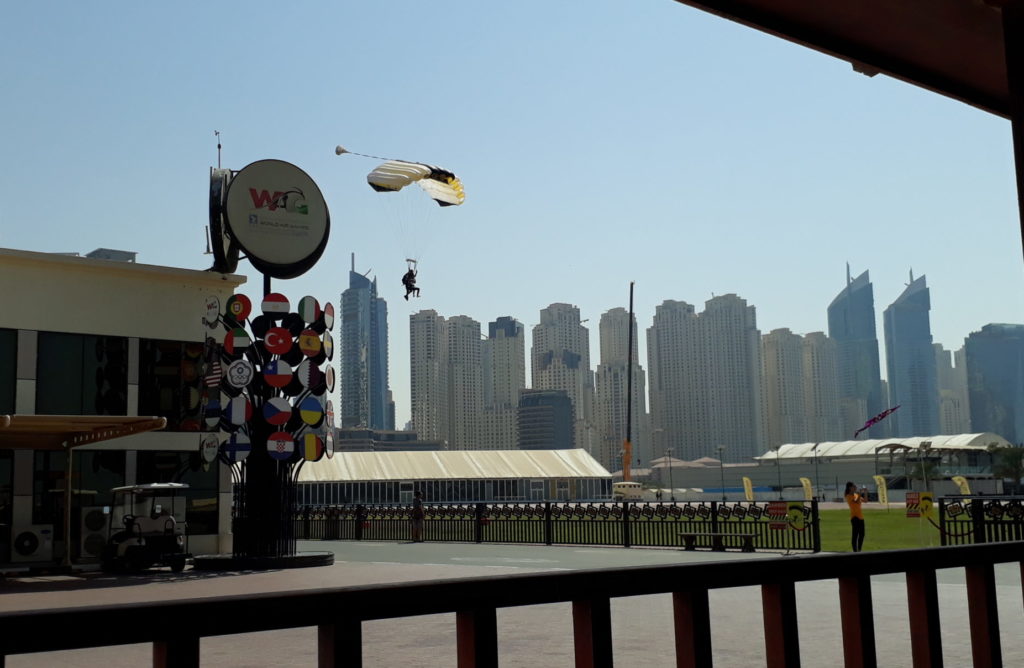 Tandem skydivers landing next to Dubai buildings